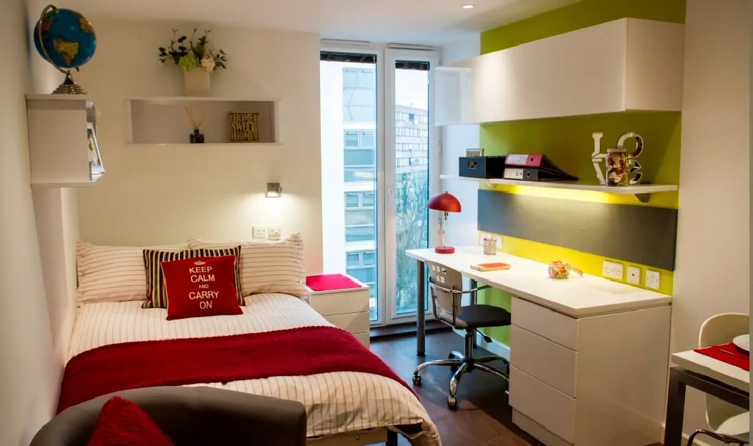 Bed desk globe and shelves student room at Griffon Studios in London Student Accommodation
