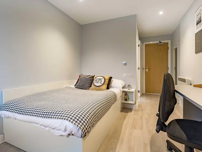 Bed desk chair and door bedroom at Mary Parker House in Plymouth Student Accommodation
