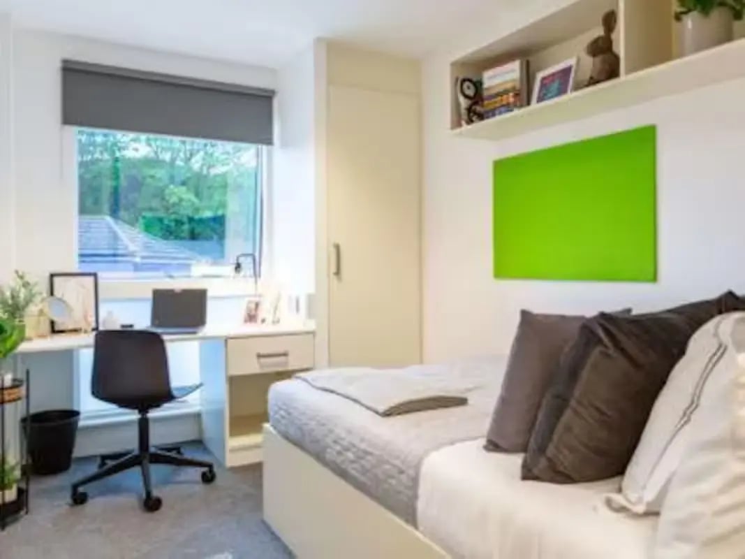 Bed desk chair pillows and window bedroom at Harbour Court in Bristol Student Accommodation