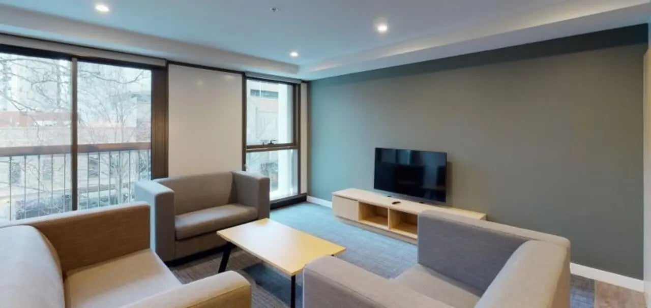 Sofas coffee table television living room at Unilodge Melbourne City in Melbourne Student Accommodation