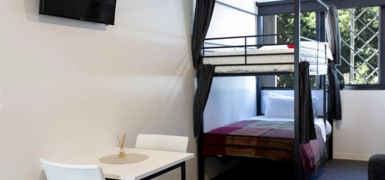 Bunk beds and table with chairs bedroom at Unilodge South Bank in Brisbane Student Accommodation