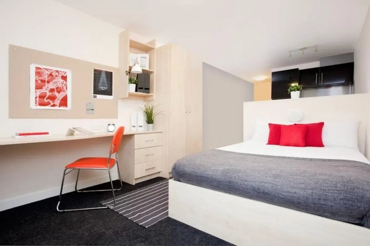Bed desk wardrobe and kitchen area bedroom at Studio 58 in Bristol Student Accommodation
