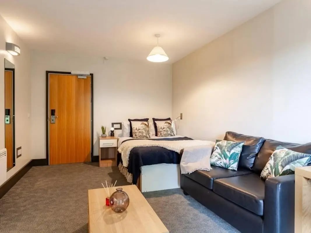 Bed sofa coffee table and door living room at Kendrick Hall in Reading Student Accommodation