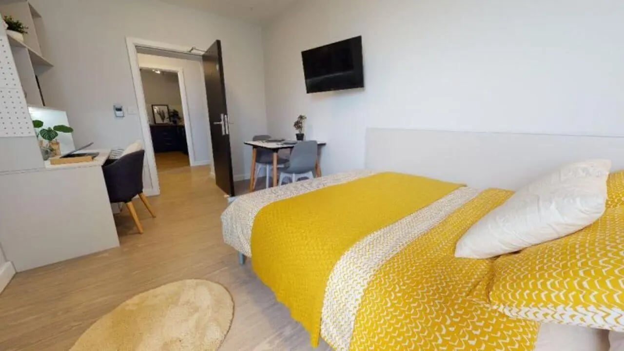 Bed desk chair table and TV bedroom at iQ Newland House in Nottingham Student Accommodation