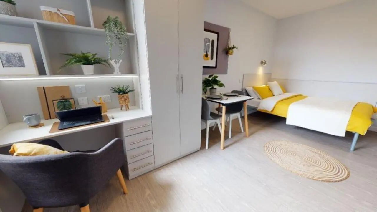 Desk chair bed table plants studio apartment at iQ Newland House in Nottingham Student Accommodation