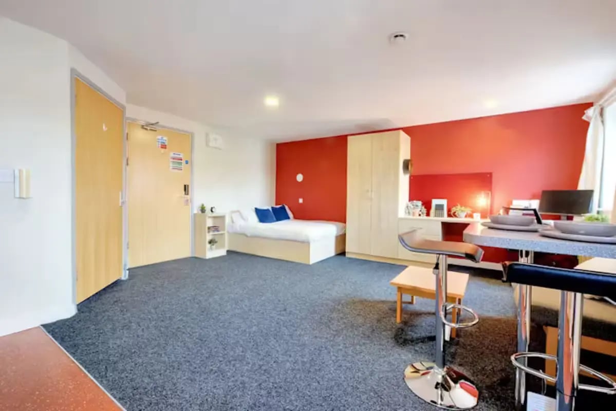 Bed wardrobe desk table and chairs studio apartment at Nottingham Two in Nottingham Student Accommodation