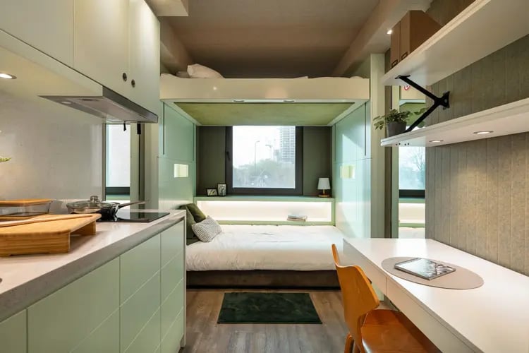 Loft bed lower bed desk and kitchen area student studio. at The Stay Club North Acton in London Student Accommodation