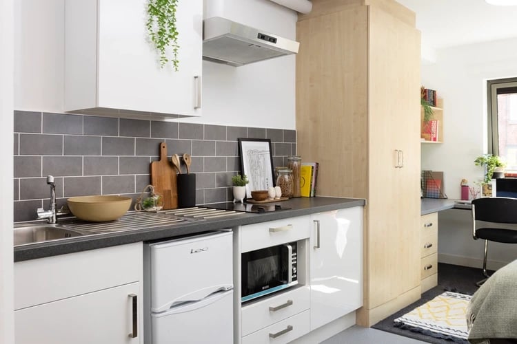 Kitchenette with microwave fridge and desk area kitchen at Sir Charles Groves Hall in Manchester Student Accommodation