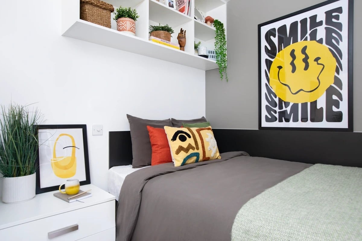 Bed with colorful pillows and modern art bedroom at Campbell House in Bristol Student Accommodation