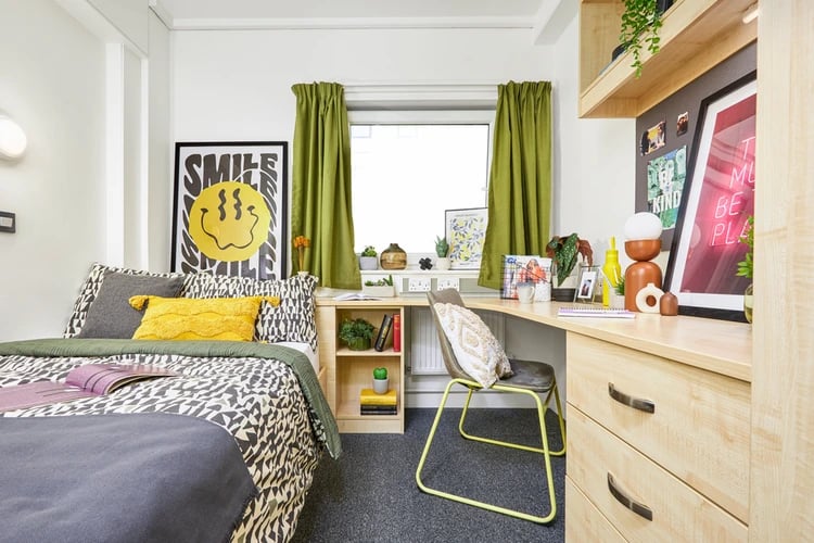 Bed desk chair poster bedside table bedroom at Harriet Martineau in Birmingham Student Accommodation