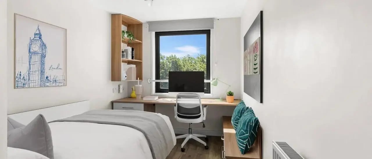 Bed desk chair bookshelf London poster bedroom at Chapter Islington in London Student Accommodation