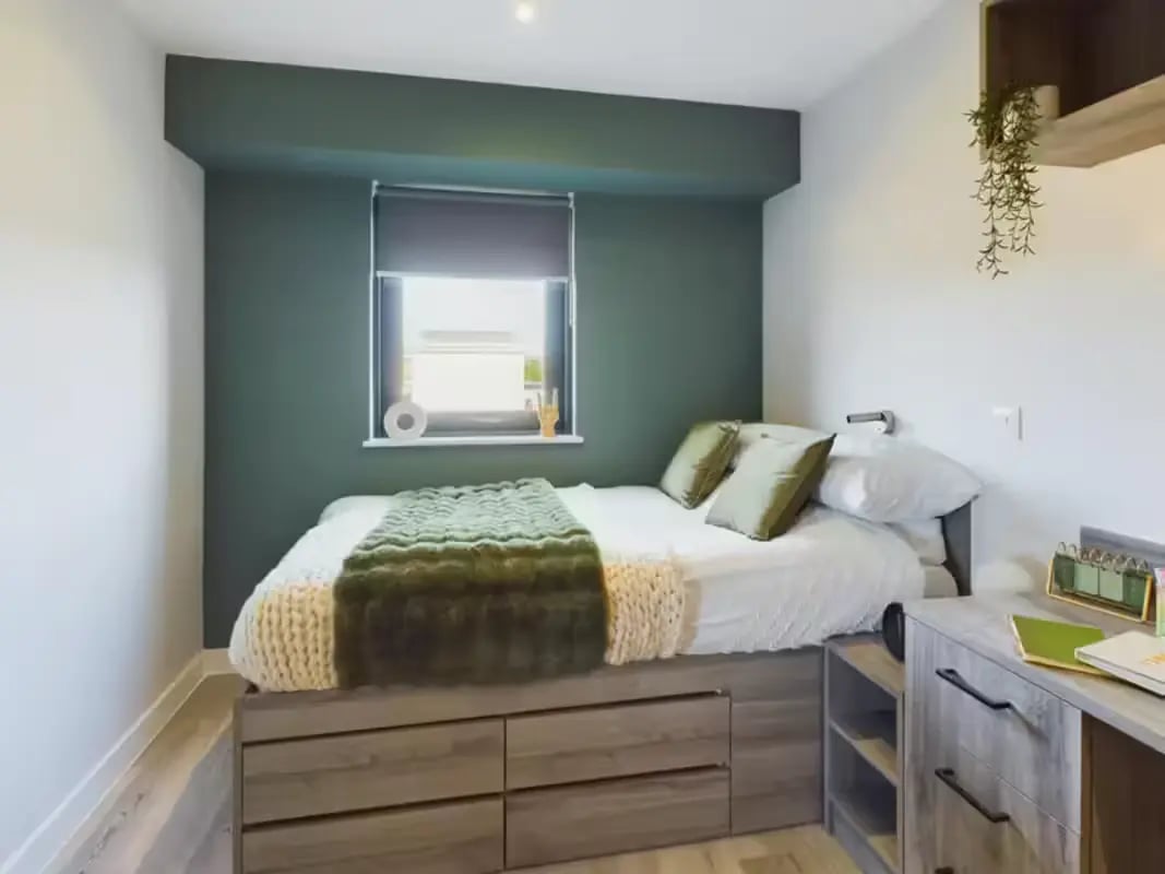 Bed with green throw drawer storage desk bedroom at Crown Place - Nottingham in Nottingham Student Accommodation