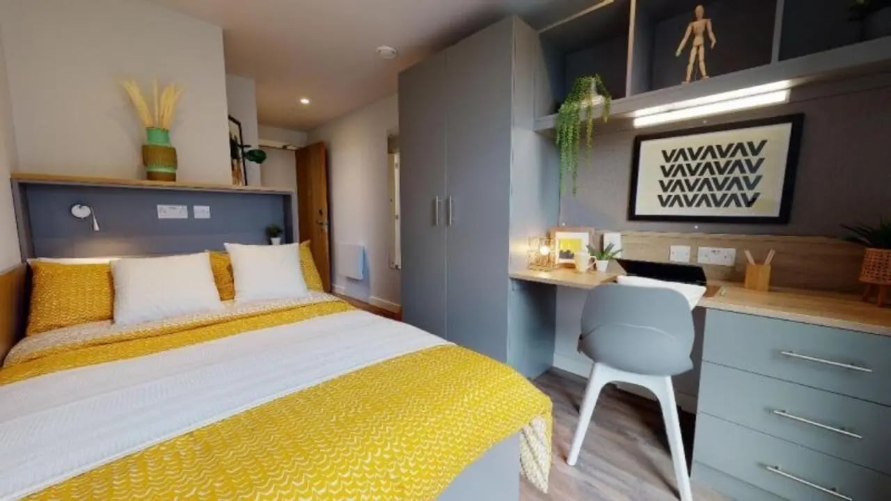 Bed desk wardrobe with study decor bedroom at iQ Altus House in Leeds Student Accommodation