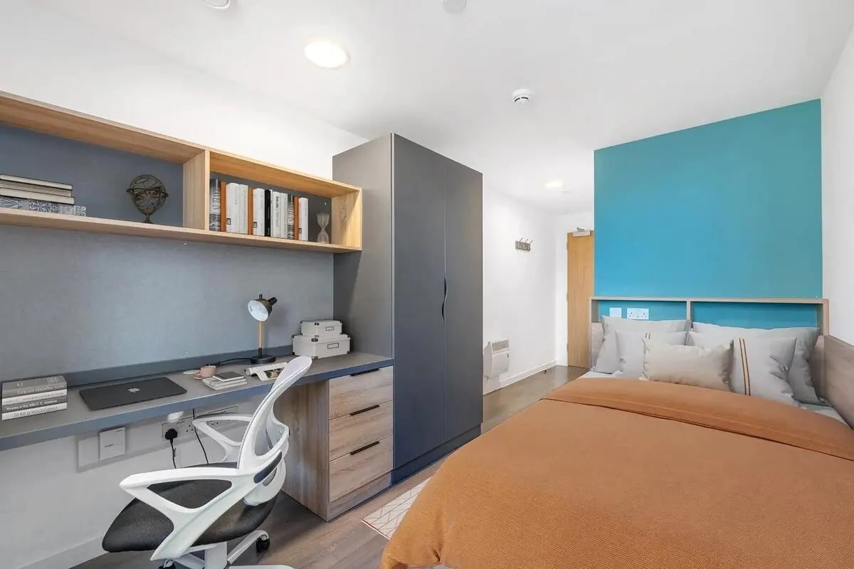 Desk with chair bed and wardrobe bedroom at Canvas Walthamstow in London Student Accommodation