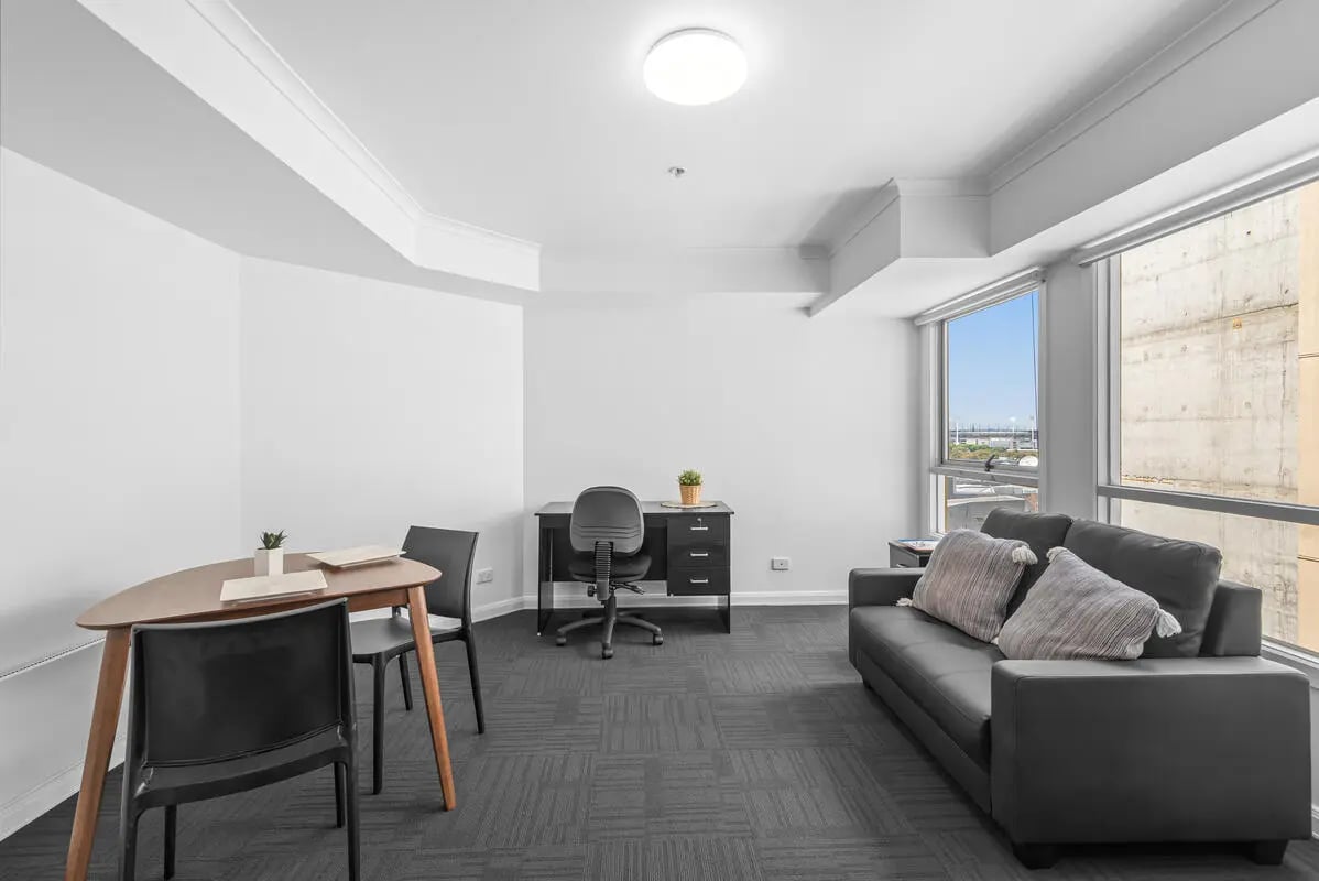 Sofa desk chairs table living room at Student Living on Flinders in Melbourne Student Accommodation