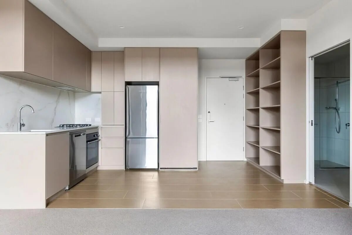 Modern kitchen with fridge oven shelves living room at Realm Caulfield in Melbourne Student Accommodation