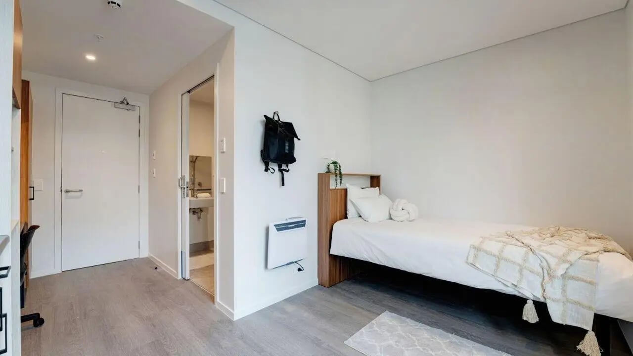 Bed desk heater and backpack bedroom at UniLodge Auckland Central in Auckland Student Accommodation