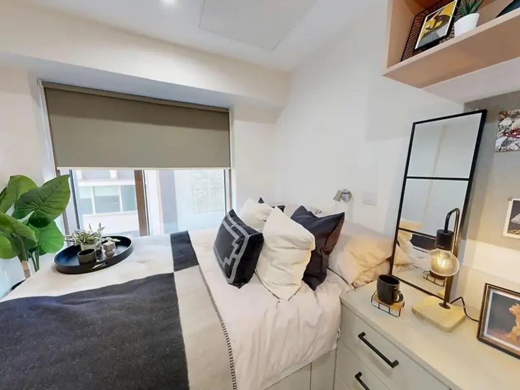 Bed with pillows blanket and tray bedroom at Yugo Crown Place in Birmingham Student Accommodation