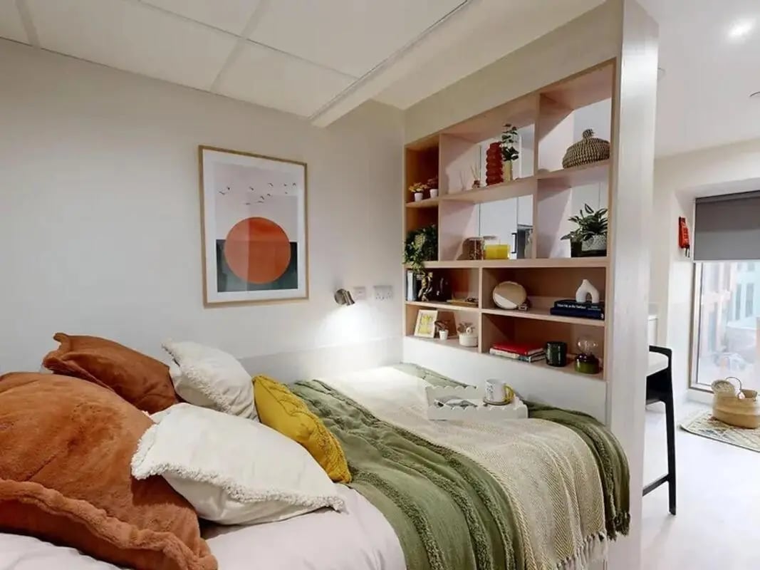Bed with pillows shelf and art bedroom at Yugo Crown Place in Birmingham Student Accommodation