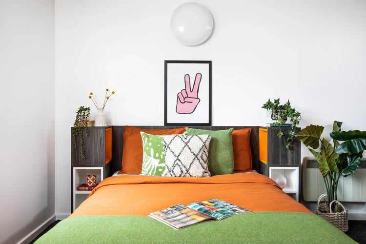 Orange bed with green throw peace art bedroom at Orion Point in Southampton Student Accommodation