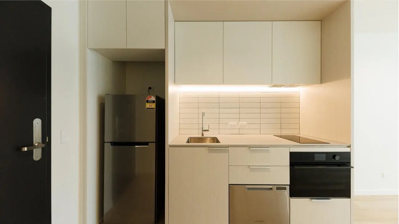 Modern kitchen with stainless steel fridge and oven kitchen at West Tower, Melbourne Quarter in Melbourne Student Accommodation