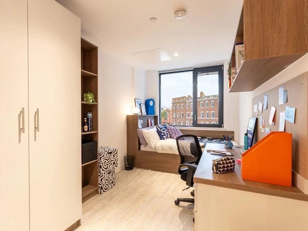 Wardrobe bed desk chair bookshelf bedroom study area at Glassworks in Bristol Student Accommodation