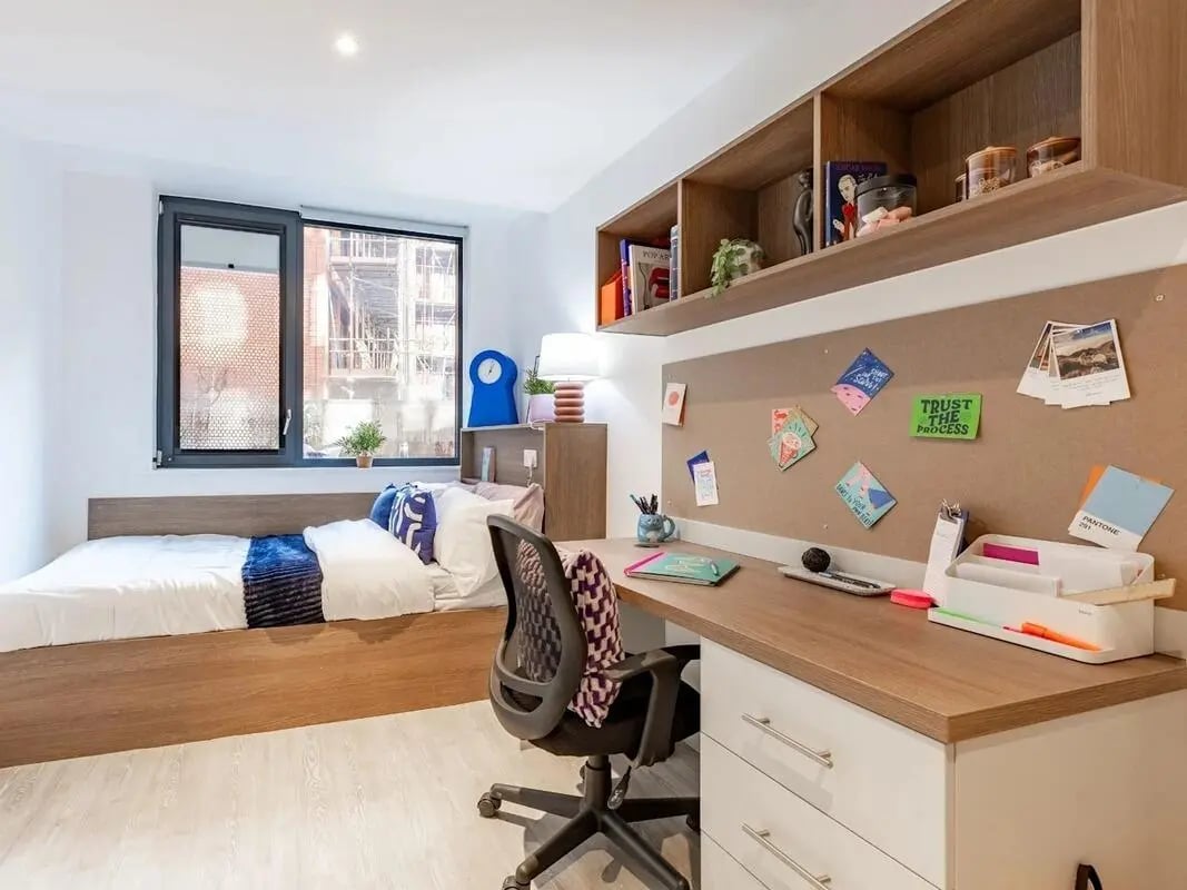 Bed desk chair shelves pinned notes bedroom at Glassworks in Bristol Student Accommodation