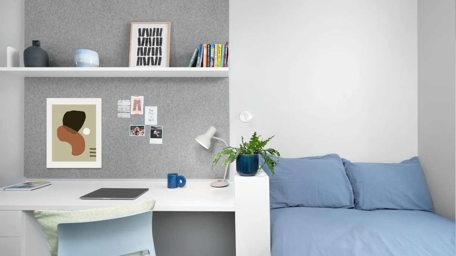 Desk with laptop and bed student room at Scape Canada Water in London Student Accommodation