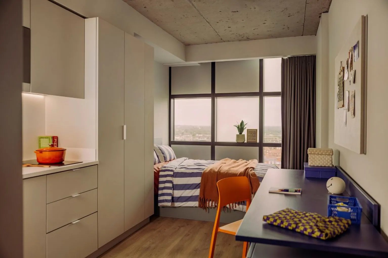 Bed kitchen cabinets desk and chair study room at Scape Hammersmith in London Student Accommodation