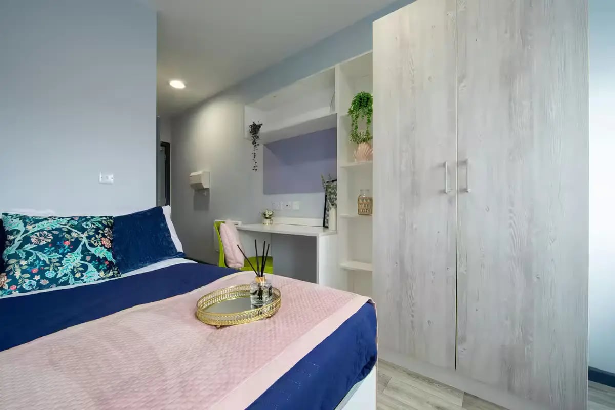 Bed with decorative pillows and diffuser bedroom at dwell Archer House in Nottingham Student Accommodation