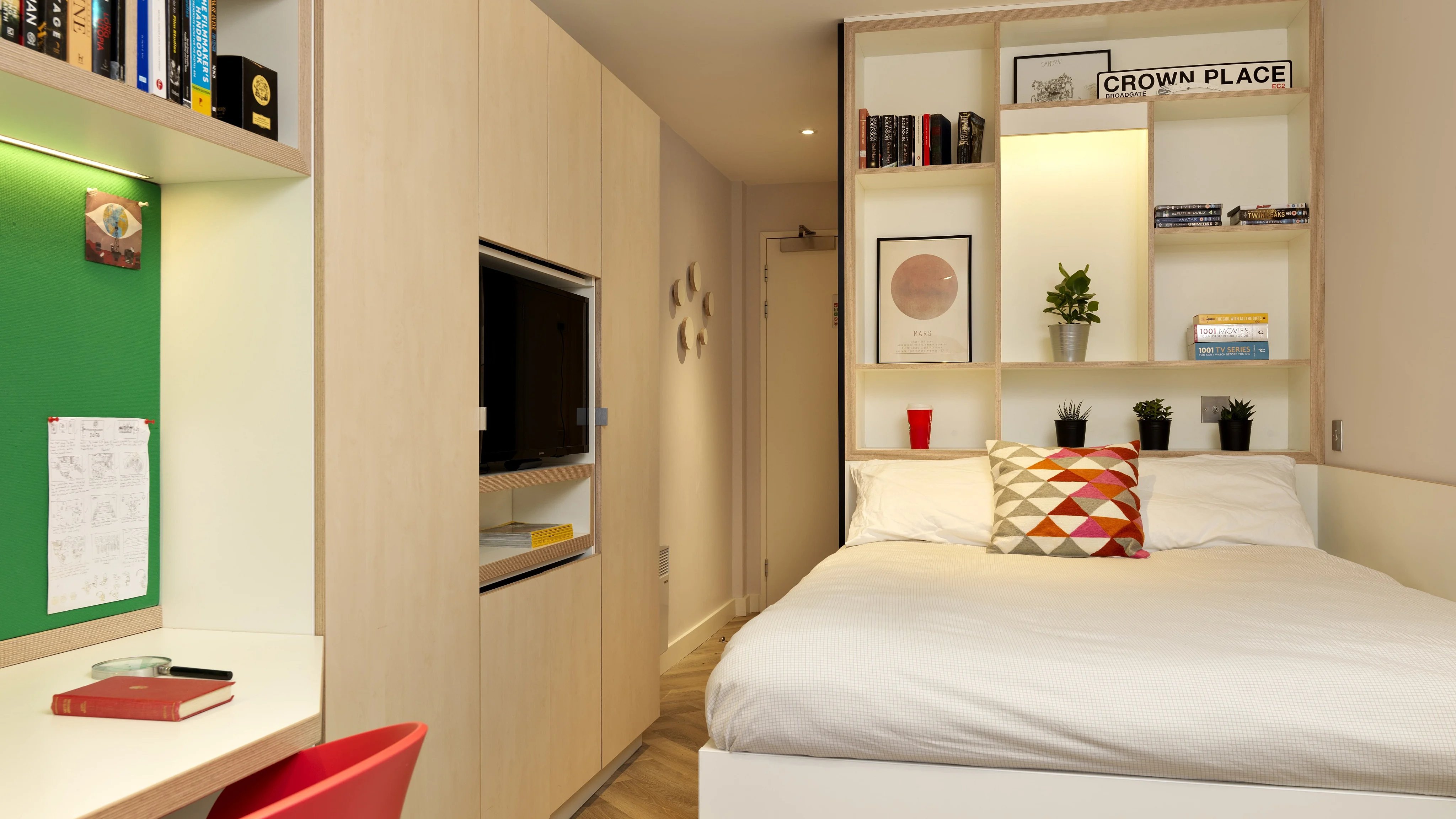 Bed with shelves desk and tv bedroom at Student Castle Cambridge in Cambridge Student Accommodation