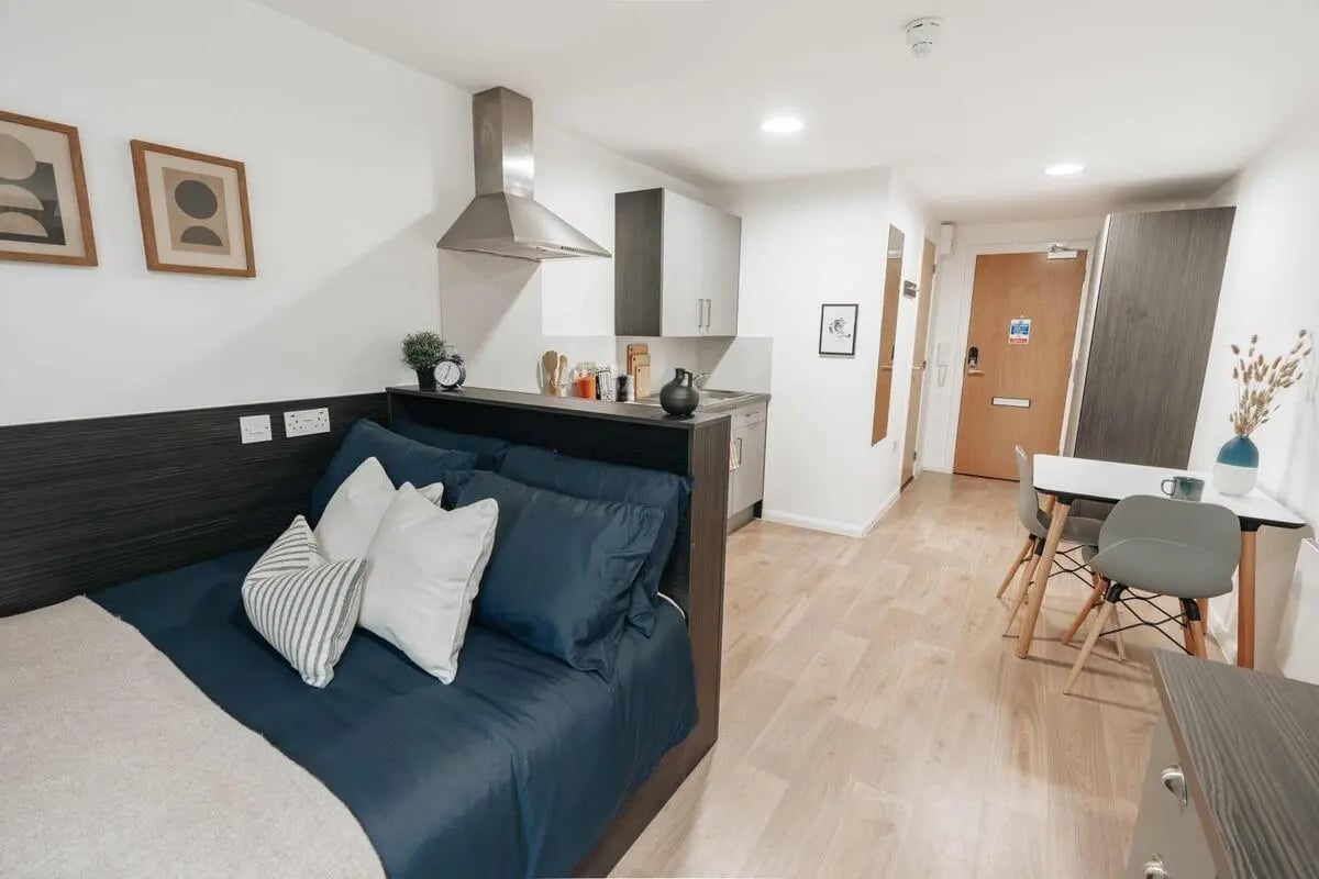 Bed kitchen dining area and door living room at Avon Studios in Bath Student Accommodation