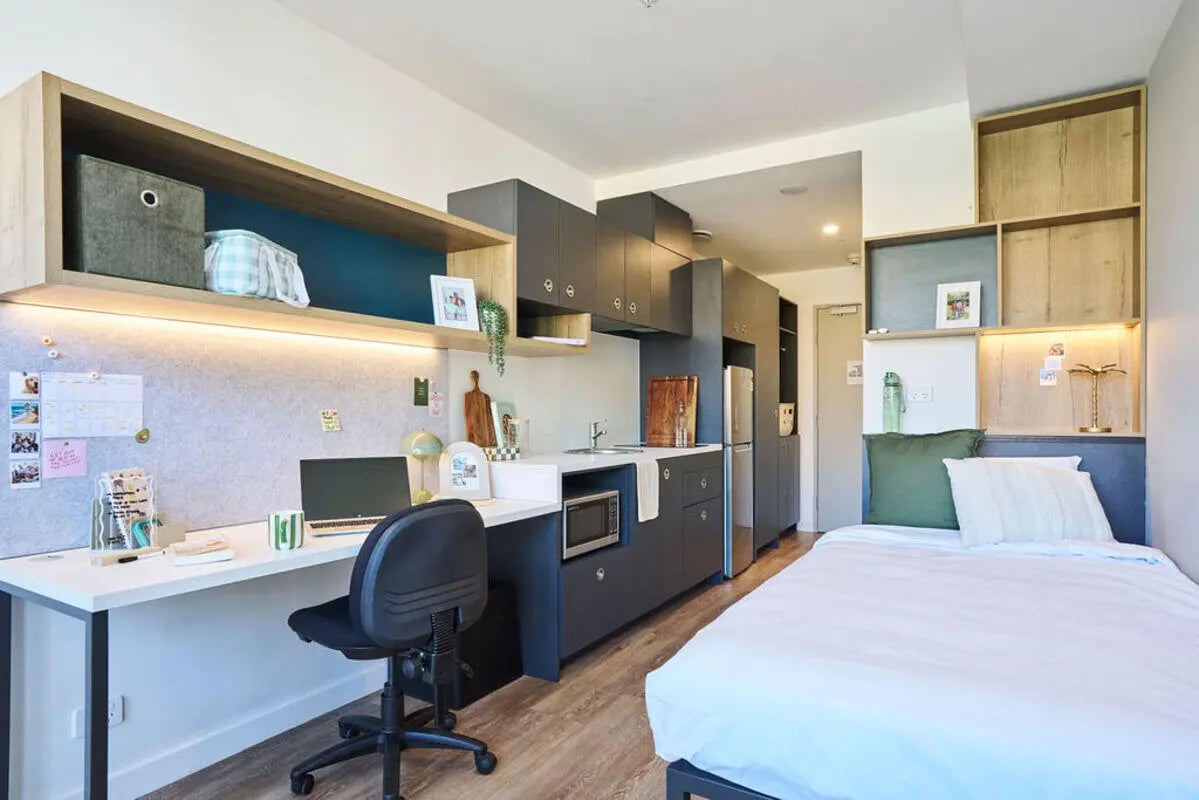 Desk bed kitchen cabinets and shelving studio apartment at UniLodge Royal Melbourne in Melbourne Student Accommodation