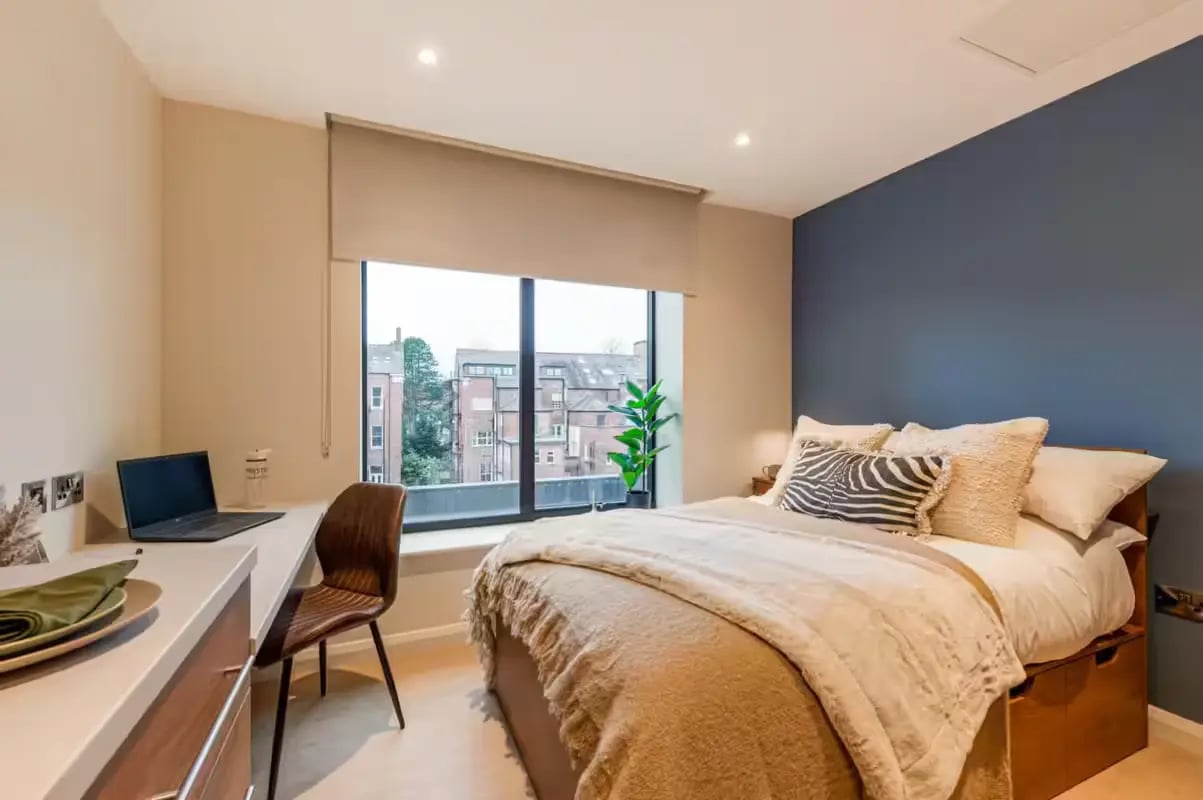 Desk laptop chair bed with pillows bedroom at Ryan Hall in Belfast Student Accommodation