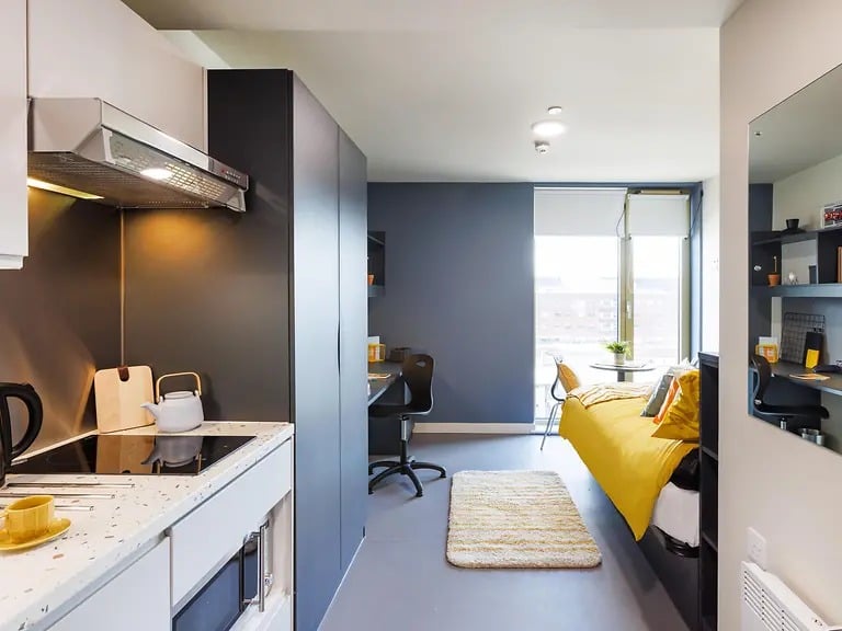 Kitchenette bed study desk and rug studio at Element Manchester in Manchester Student Accommodation