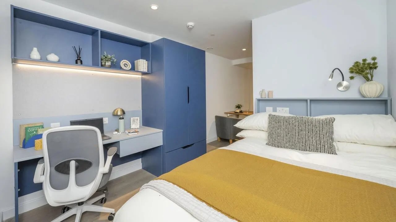Desk chair laptop shelves bed with yellow throw Bedroom at St Vincent Studios in Glasgow Student Accommodation