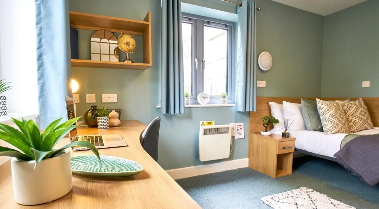 Desk bed shelf and plants bedroom at Barker House in Newcastle Upon Tyne Student Accommodation