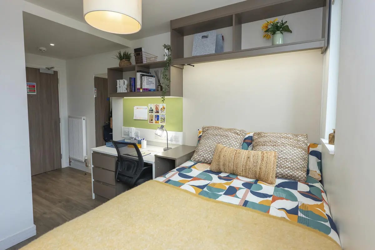 Bed desk shelves pillows bedding bedroom at Aparto Arbury Court in Kingston Upon Thames Student Accommodation