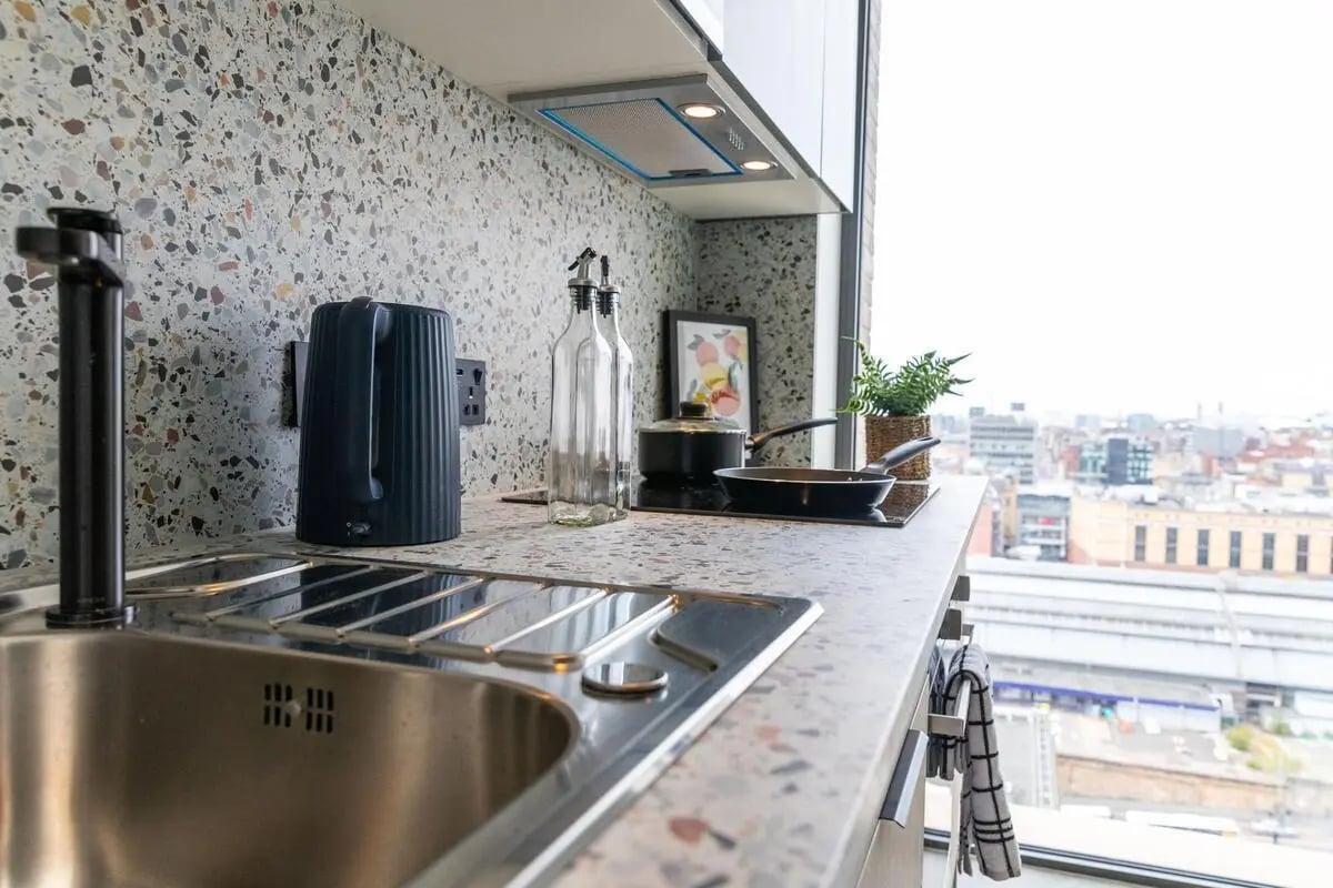 Sink kettle bottles frying pan kitchen at City Wharf in Glasgow Student Accommodation