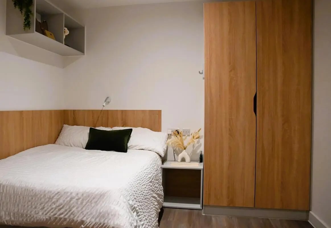 Bed bedside table and large wardrobe bedroom at Hill View Place in Exeter Student Accommodation