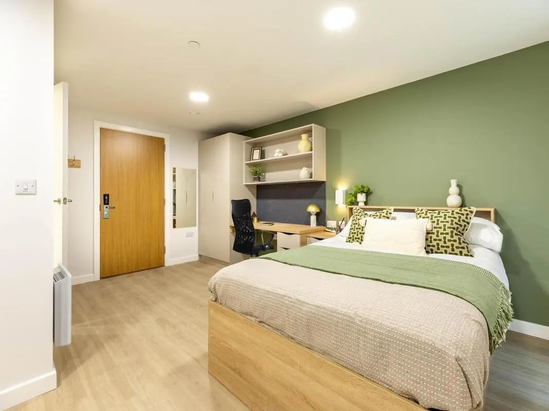 Bed desk wardrobe and door bedroom at Waterloo House in York Student Accommodation