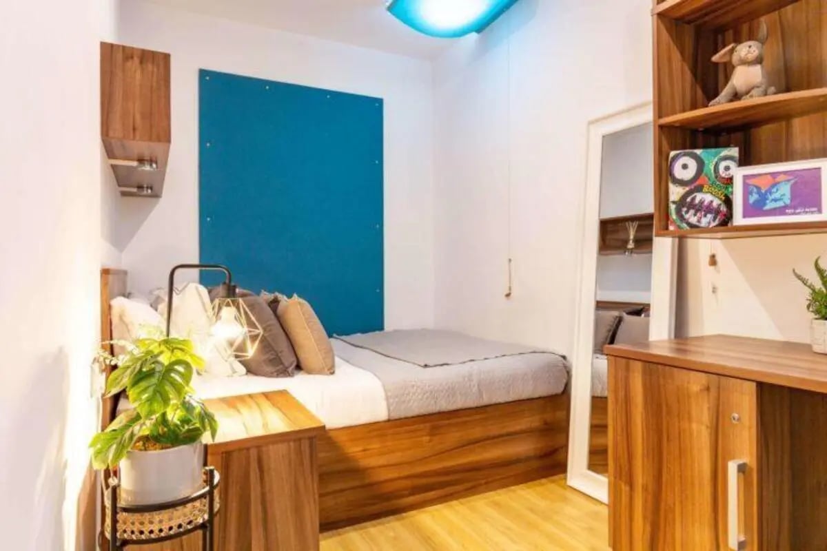 Bed with pillows and bedside table bedroom at King Square Studios in Bristol Student Accommodation