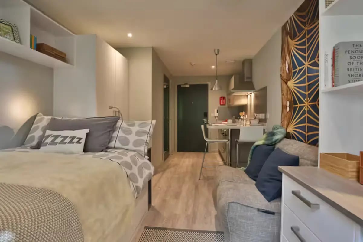 Bed sofa kitchen and door studio apartment at Buccleuch Street in Edinburgh Student Accommodation