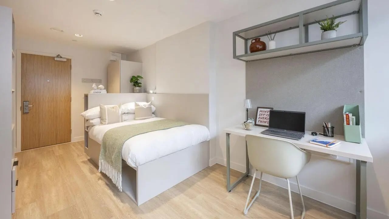 Bed desk chair and shelving unit bedroom at The Quarter House in Bristol Student Accommodation
