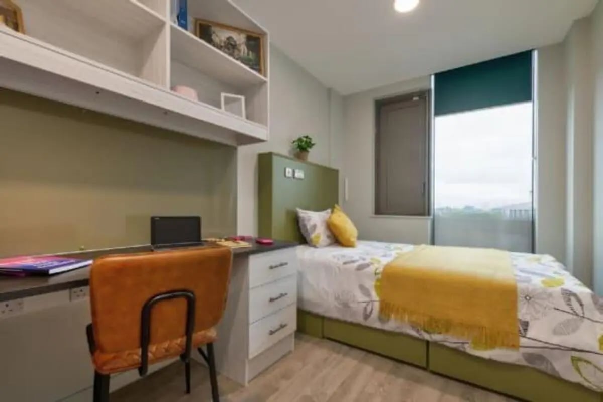 Desk chair laptop shelves and bed bedroom at Flora Building - Hoxton in London Student Accommodation