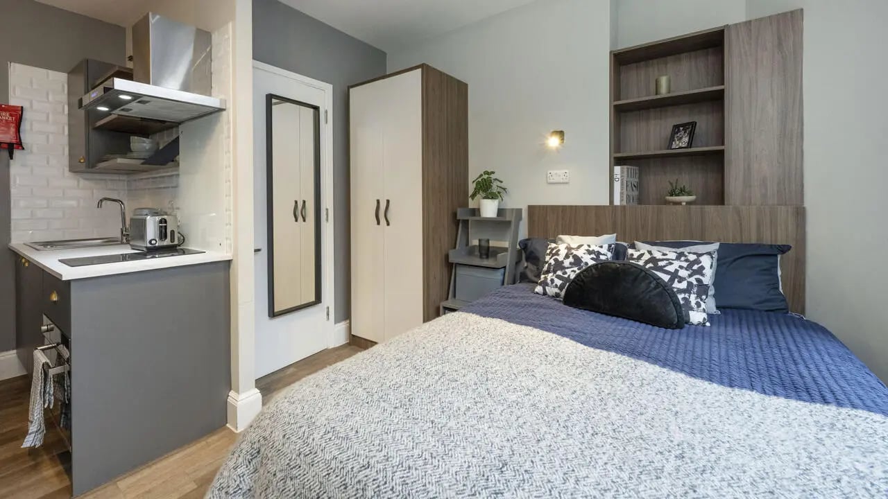 Compact kitchen bed with bookshelves and wardrobe Bedroom at Chamberlain Place in Birmingham Student Accommodation