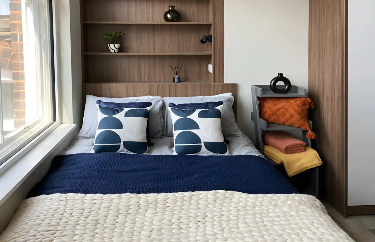 Bed pillows blankets shelves and diffuser bedroom at Chamberlain Place in Birmingham Student Accommodation