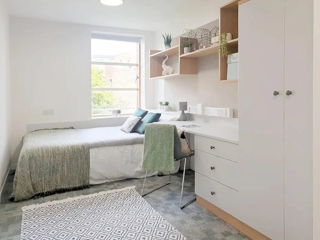 Bed desk shelving and wardrobe bedroom study area at Abode York in York Student Accommodation