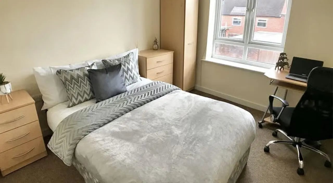Bed nightstand desk chair laptop study area at Hassells Bridge House in Newcastle Under Lyme Student Accommodation