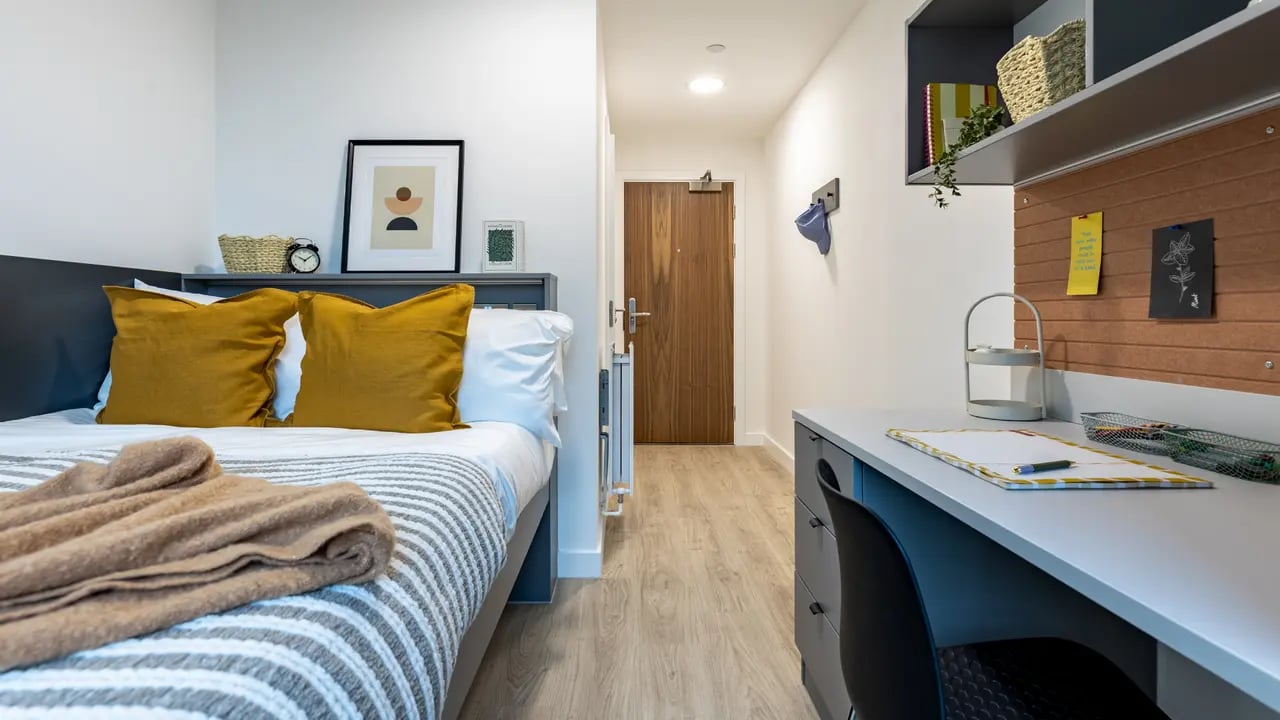 Bed desk and hallway student accommodation bedroom at Waterside in Bristol Student Accommodation